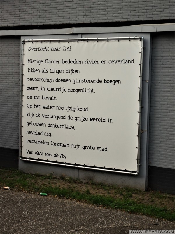 Poem 'Crossing to Tiel' by Hans van de Pol on a Building in Tiel, Netherlands Gedicht 'Overtocht naar Tiel' van Hans van de Pol op een Gebouw in Tiel, Nederland