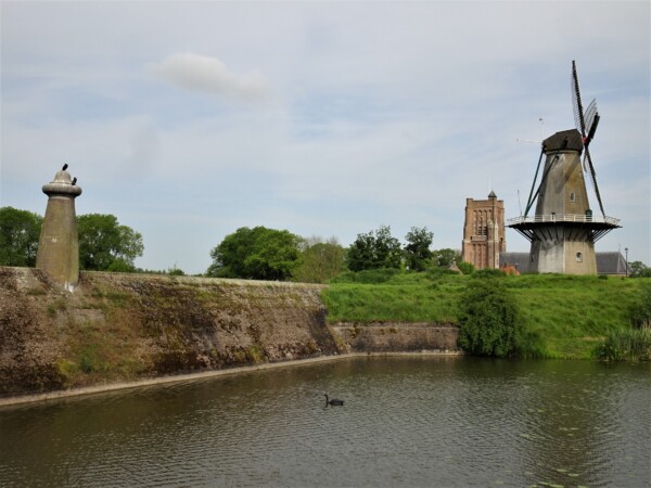 Dam, Windmill and Church in Woudrichem, the Netherlands Dam, Windmill and Church in Woudrichem, the Netherlands